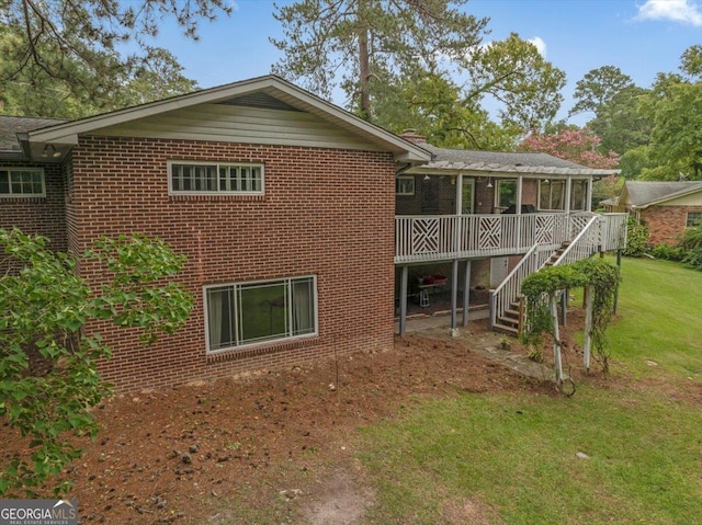 view of side of home featuring a yard and a sunroom