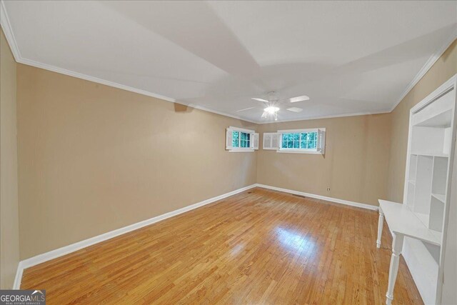 unfurnished living room featuring ceiling fan with notable chandelier, ornamental molding, brick wall, and a brick fireplace