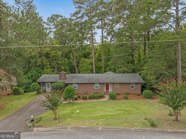 ranch-style home with a front lawn