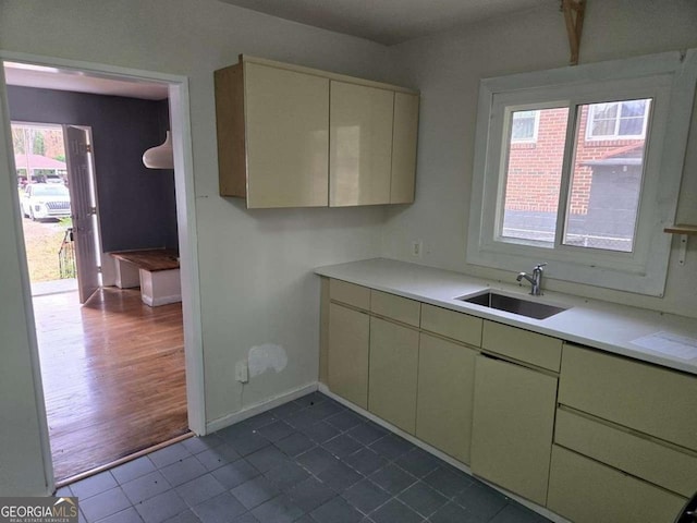 kitchen with dark tile patterned flooring and sink