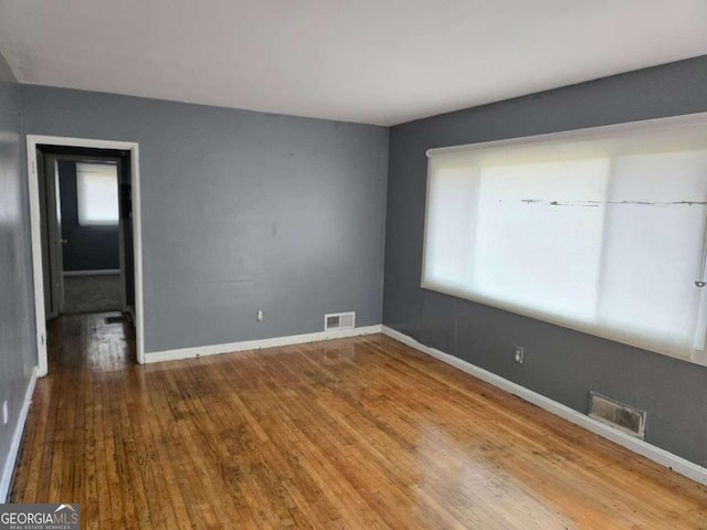 spare room with hardwood / wood-style floors