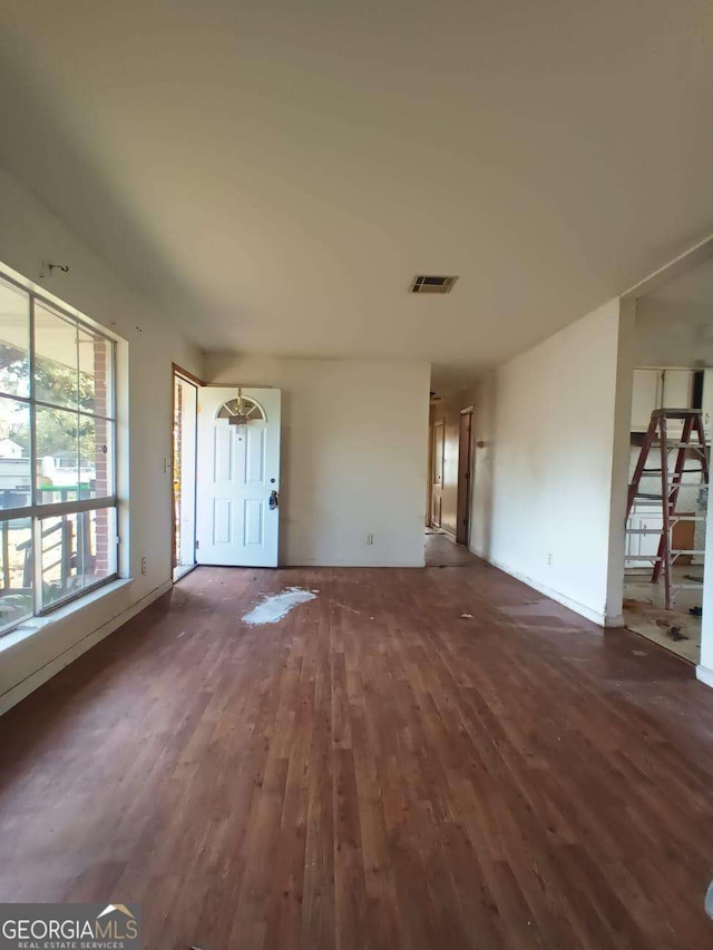 unfurnished living room with dark hardwood / wood-style floors