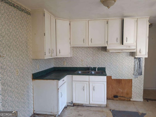 kitchen with white cabinets, sink, and tasteful backsplash