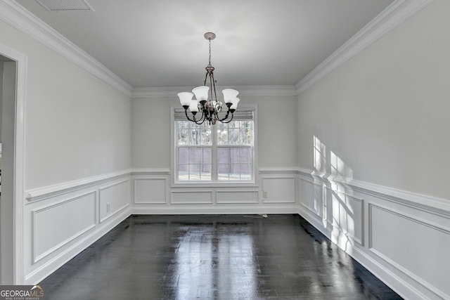 unfurnished dining area with ornamental molding and an inviting chandelier