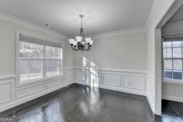 unfurnished dining area featuring ornamental molding, an inviting chandelier, and a healthy amount of sunlight