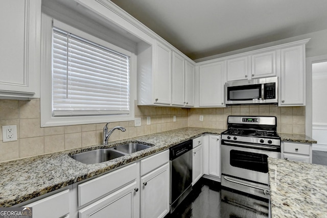 kitchen with sink, tasteful backsplash, light stone counters, white cabinetry, and stainless steel appliances