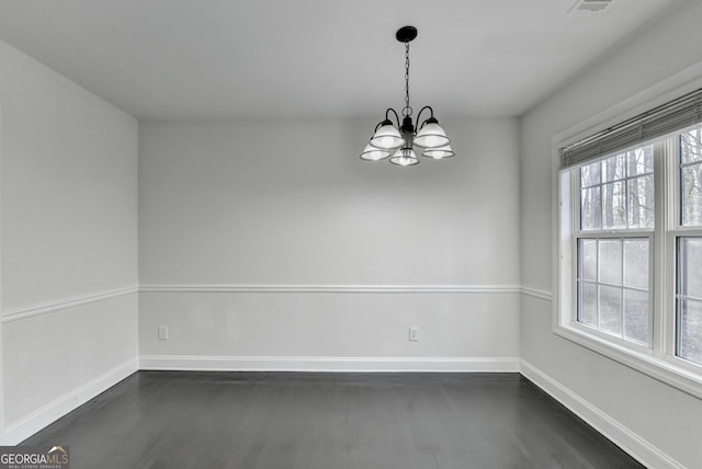 unfurnished room featuring an inviting chandelier