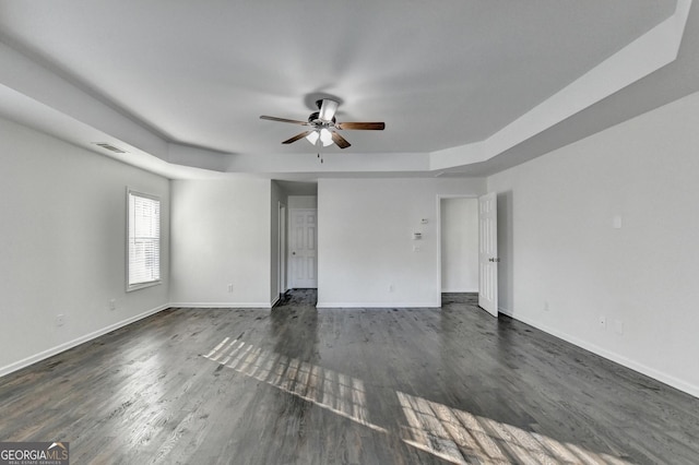 empty room featuring ceiling fan and dark hardwood / wood-style flooring