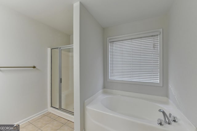 bathroom with separate shower and tub and tile patterned flooring