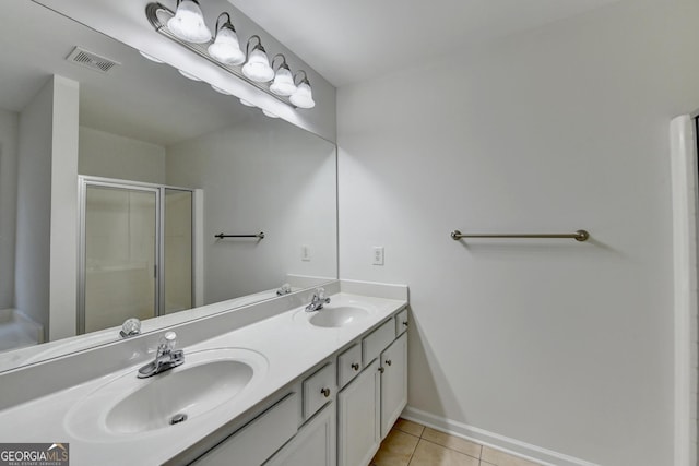 bathroom featuring tile patterned flooring, vanity, and walk in shower