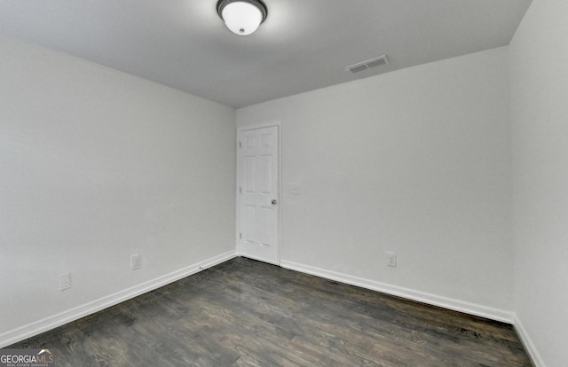 spare room featuring dark hardwood / wood-style flooring