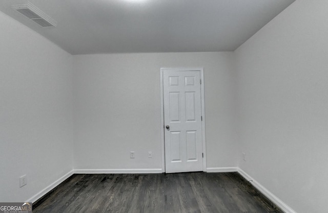 spare room with dark wood-type flooring