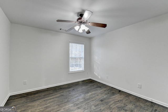 spare room featuring ceiling fan and dark wood-type flooring