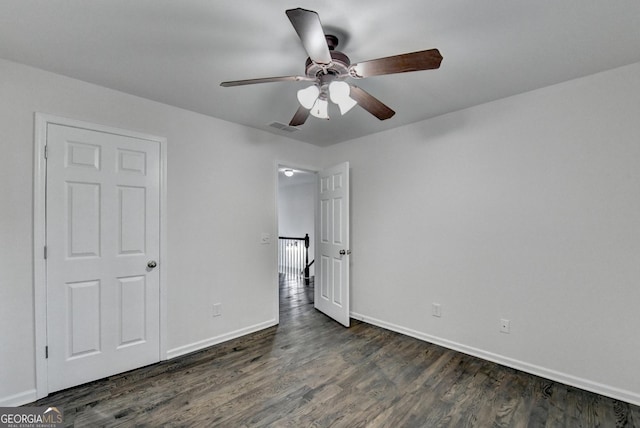 unfurnished bedroom featuring ceiling fan and dark hardwood / wood-style floors