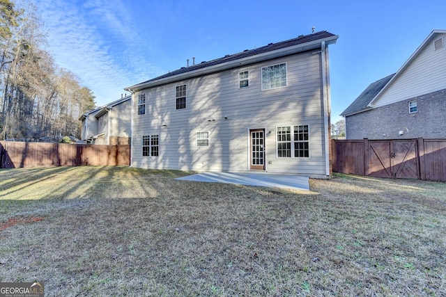 rear view of property featuring a patio area and a yard