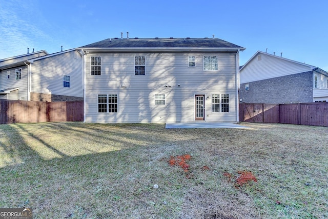 rear view of house with a patio area and a yard