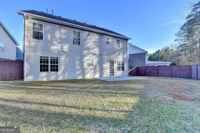 back of house featuring a patio area and a yard