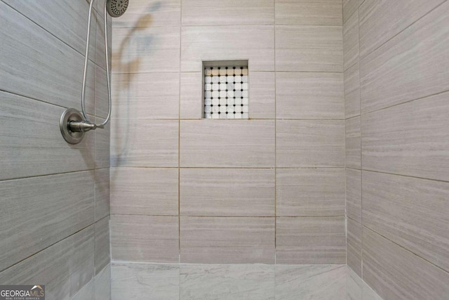 bathroom with a tile shower