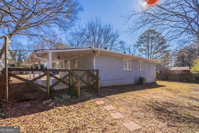 view of side of home featuring a carport and cooling unit