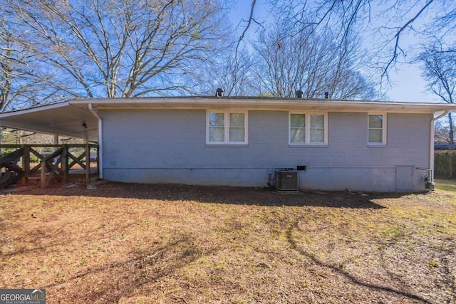 back of property with central AC and a carport