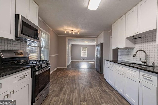 kitchen featuring sink, white cabinets, and stainless steel appliances