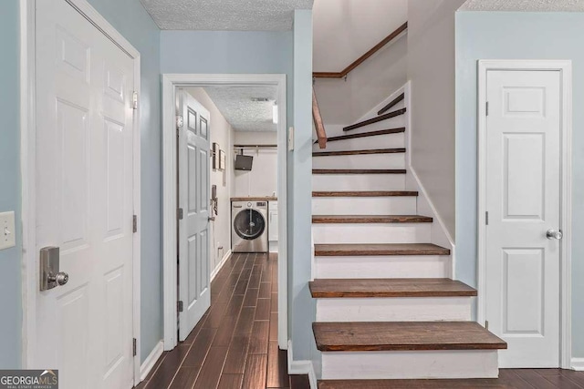 staircase with washer and clothes dryer and a textured ceiling