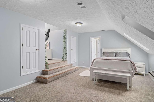 bedroom with carpet floors, a textured ceiling, and vaulted ceiling