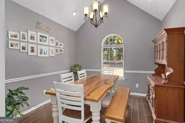 dining area with a chandelier, a textured ceiling, and high vaulted ceiling