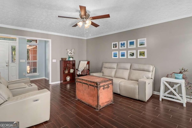 living room featuring ceiling fan, crown molding, and a textured ceiling