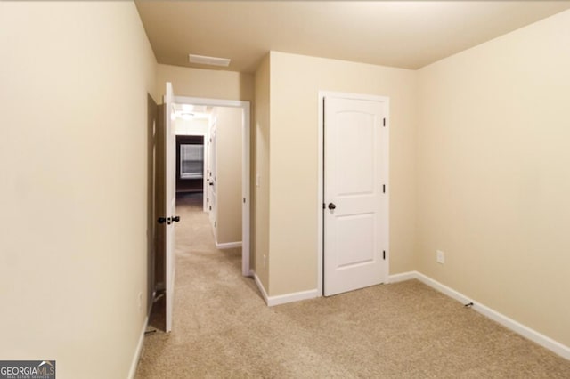 hall with light colored carpet