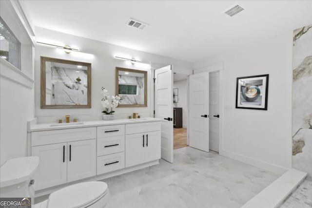 bathroom with vanity and toilet