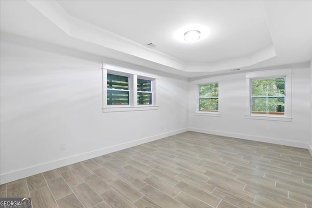 spare room with a tray ceiling