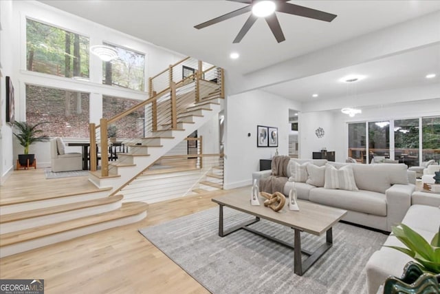 living room with ceiling fan and hardwood / wood-style floors