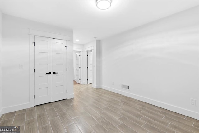 spare room featuring light hardwood / wood-style floors