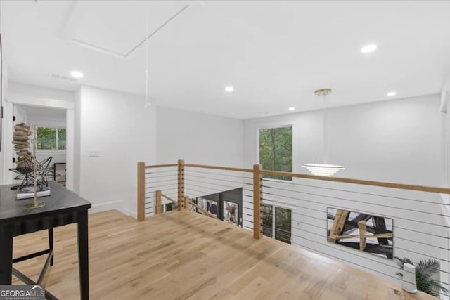 hallway with hardwood / wood-style floors