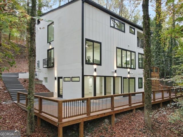 rear view of property featuring a wooden deck