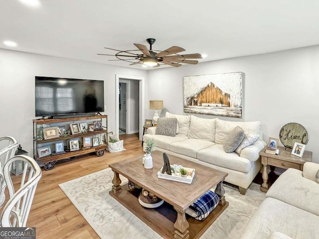 living room featuring hardwood / wood-style flooring and ceiling fan