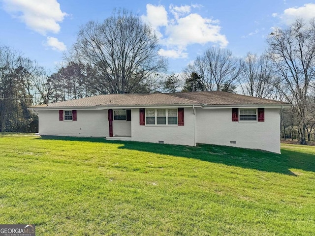 rear view of house featuring a yard