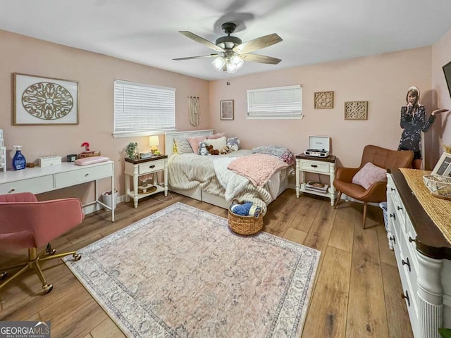 bedroom with ceiling fan and light hardwood / wood-style floors