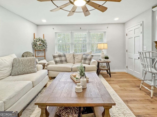 living room with ceiling fan and light hardwood / wood-style floors