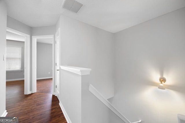 corridor with dark hardwood / wood-style floors