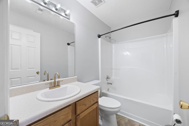 full bathroom with vanity, bathtub / shower combination, a textured ceiling, and toilet