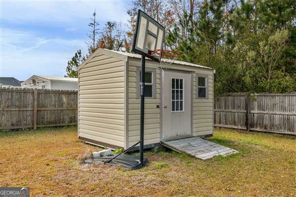 view of outbuilding with a yard