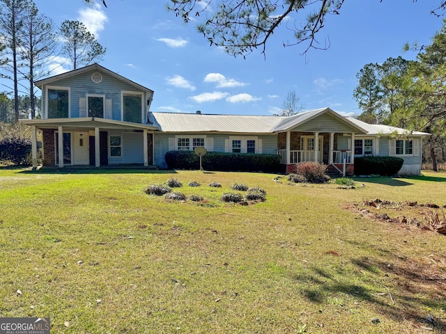 view of front of home with covered porch and a front yard