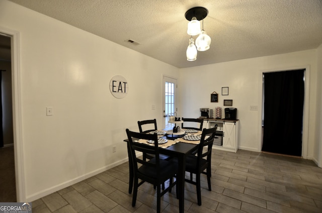 dining room featuring a textured ceiling