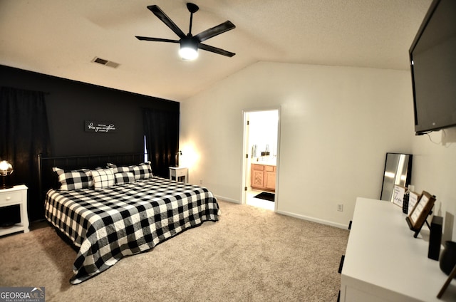 bedroom featuring light carpet, ensuite bathroom, ceiling fan, and lofted ceiling