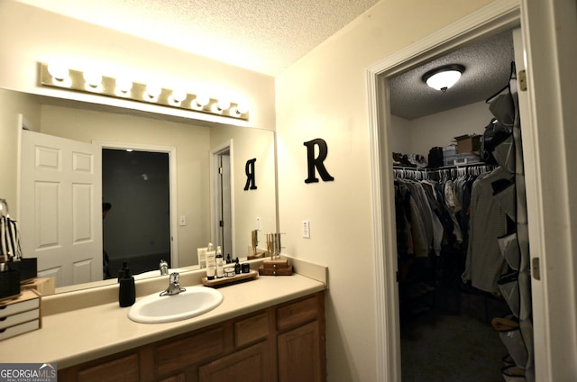 bathroom with vanity and a textured ceiling