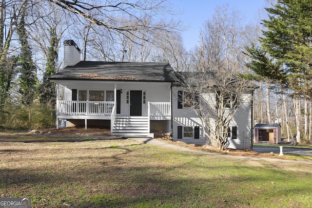 view of front of house with a front yard and a porch