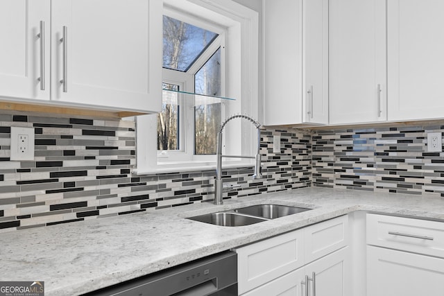 kitchen featuring white cabinetry and sink