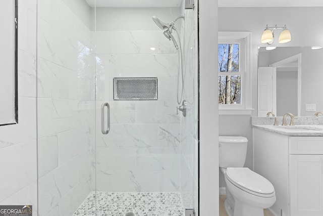 bathroom featuring vanity, toilet, and an enclosed shower